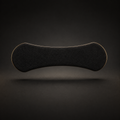 A curved black nasal strip  with a thin gold-toned edge, shown floating against a dark gradient background.